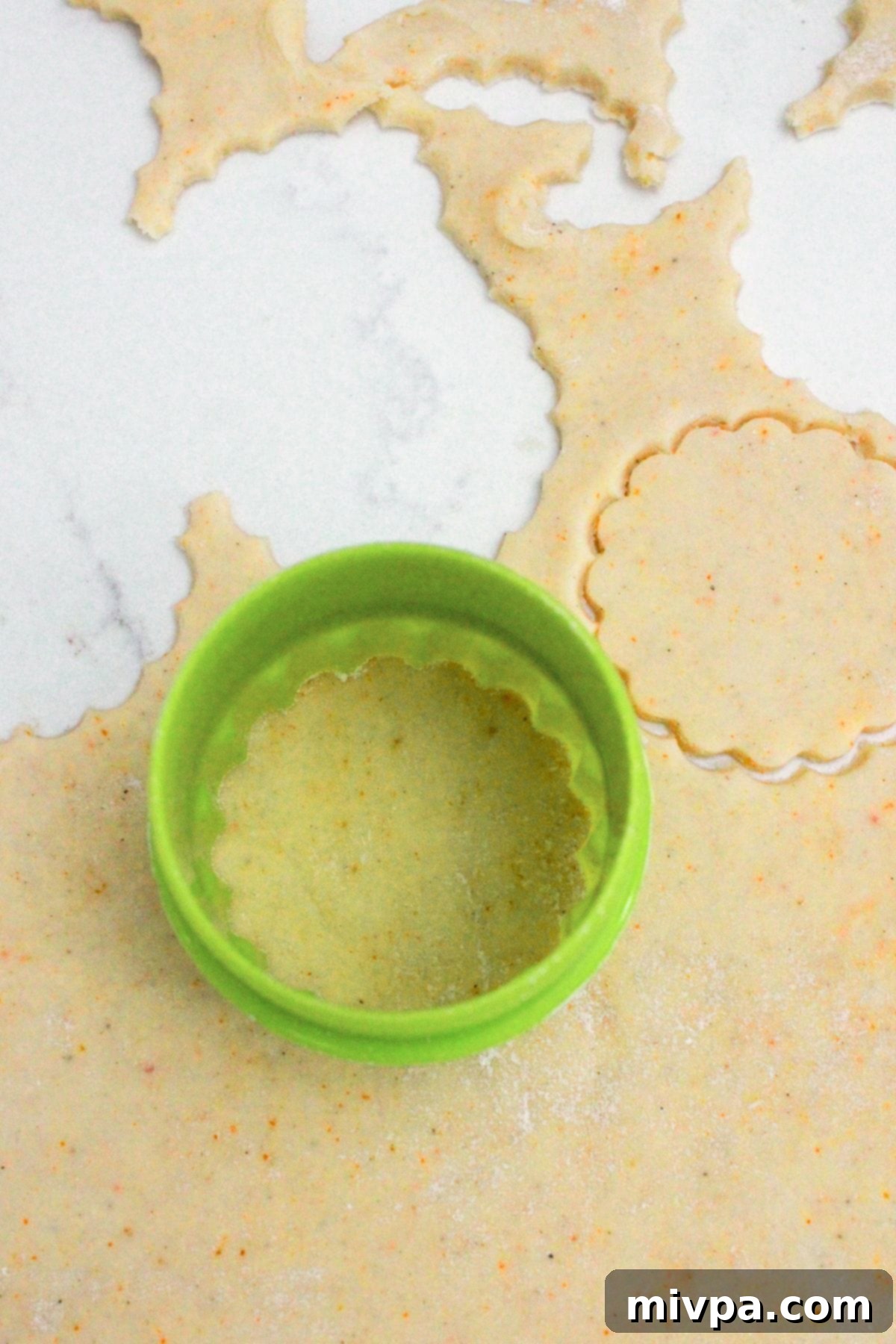 Gluten-Free Ritz Cracker Recipe (Dairy-Free Option) Cutting out shapes with round scalloped cookie cutter