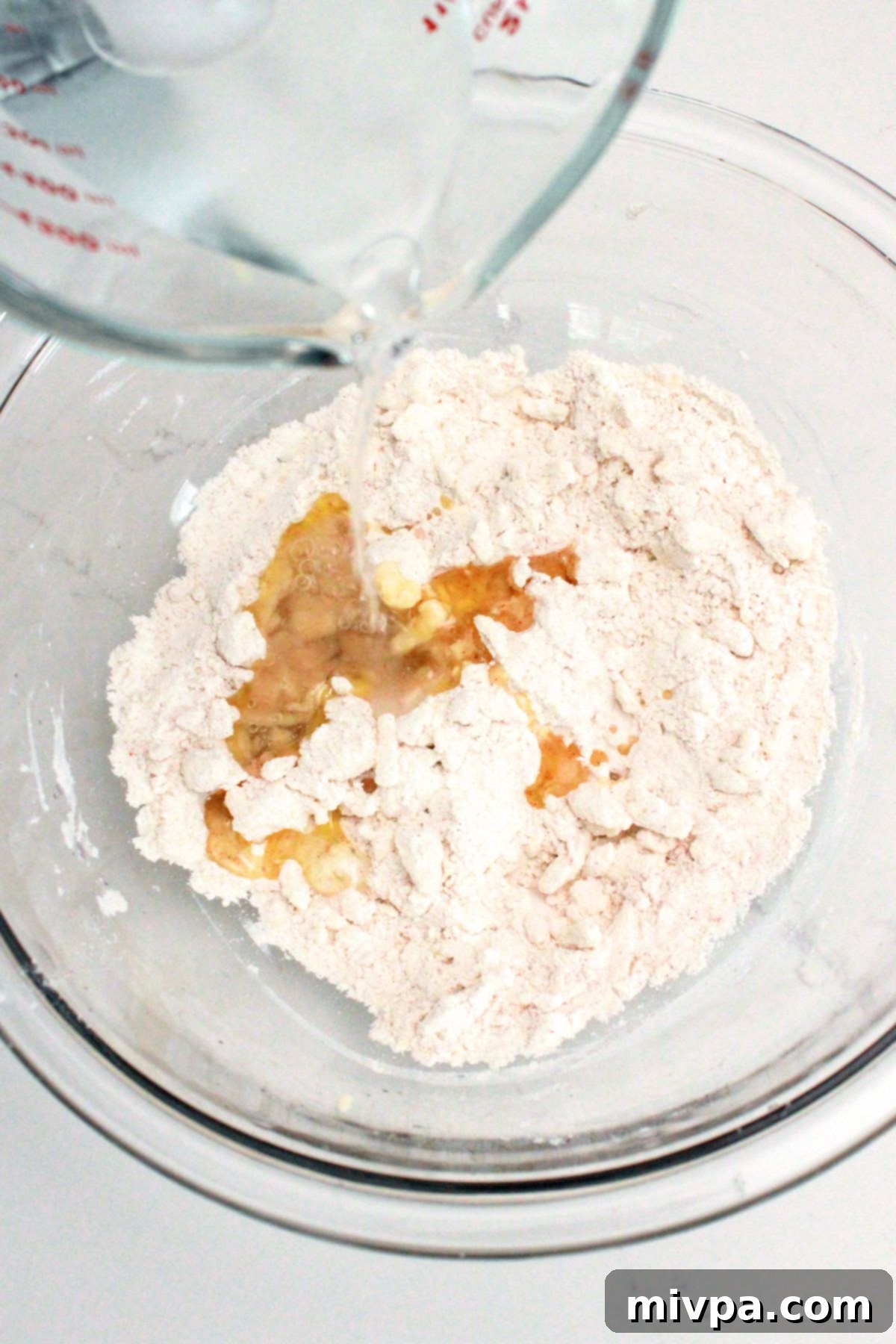 Gluten-Free Ritz Crackers (Dairy-Free Option) Pouring liquid over flour mixture