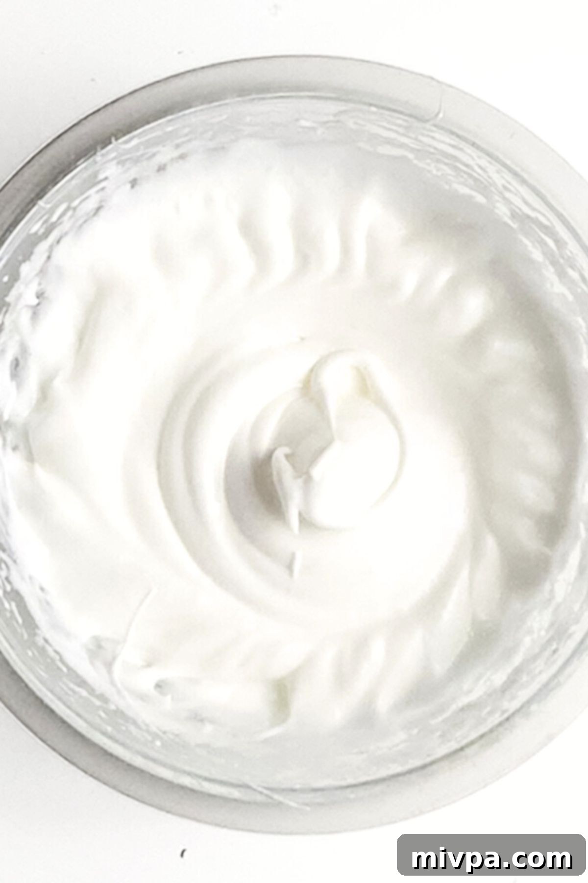 Beaten egg whites in bowl