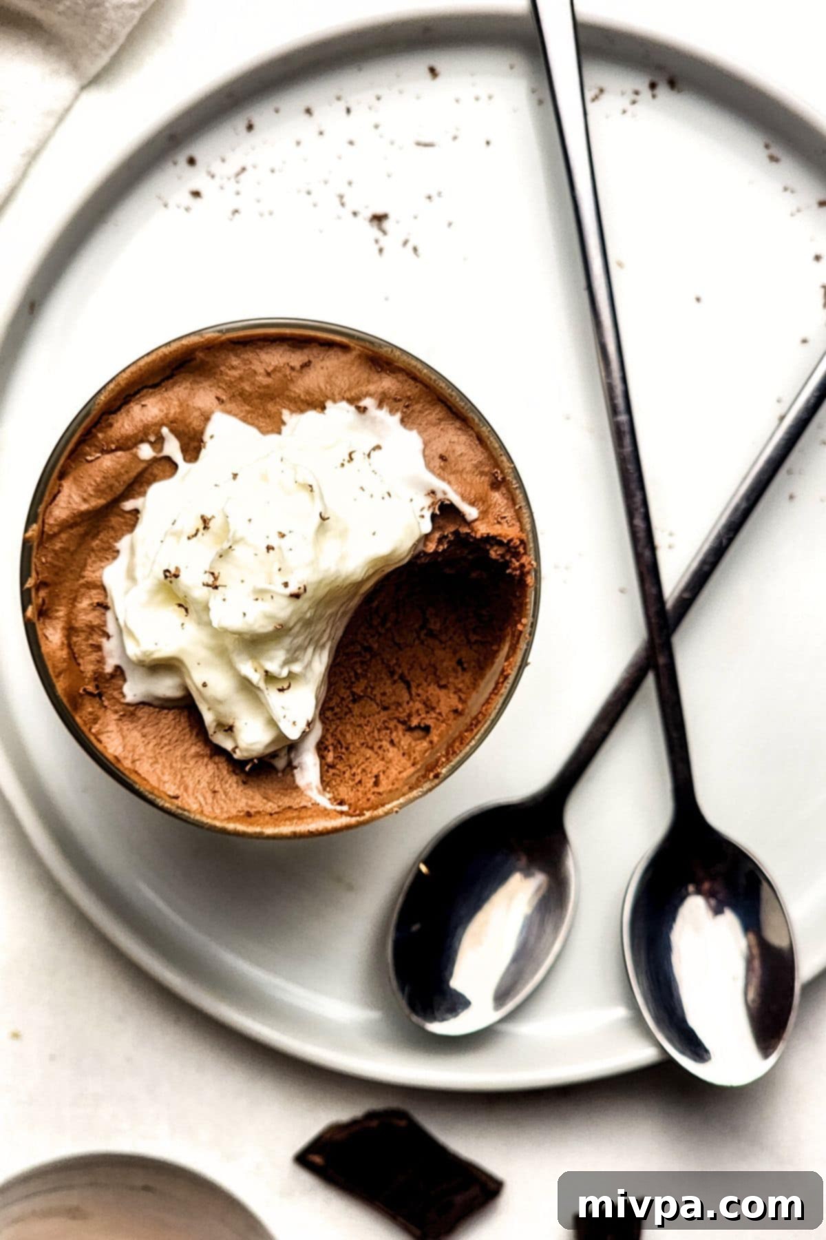 Top down view of glass of half-eaten chocolate mousse