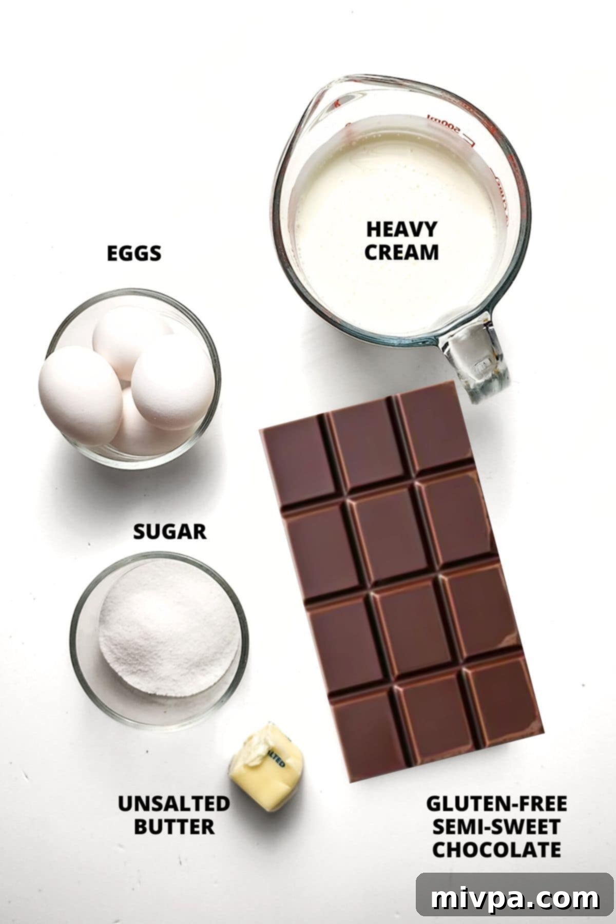 Ingredients for chocolate mousse recipe laid out on white board