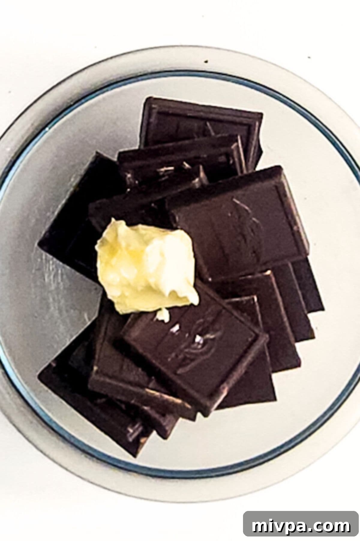 Chocolate pieces and butter in glass bowl