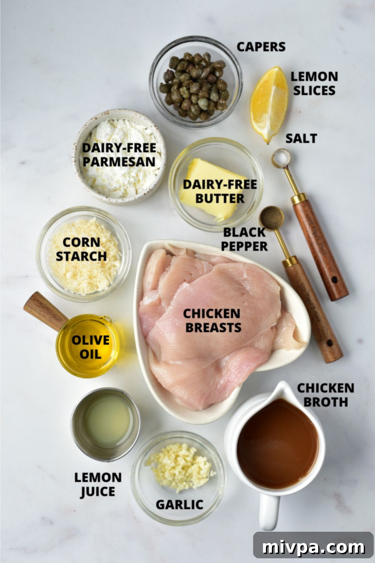 Ingredients for gluten-free chicken piccata recipe laid out on marble board