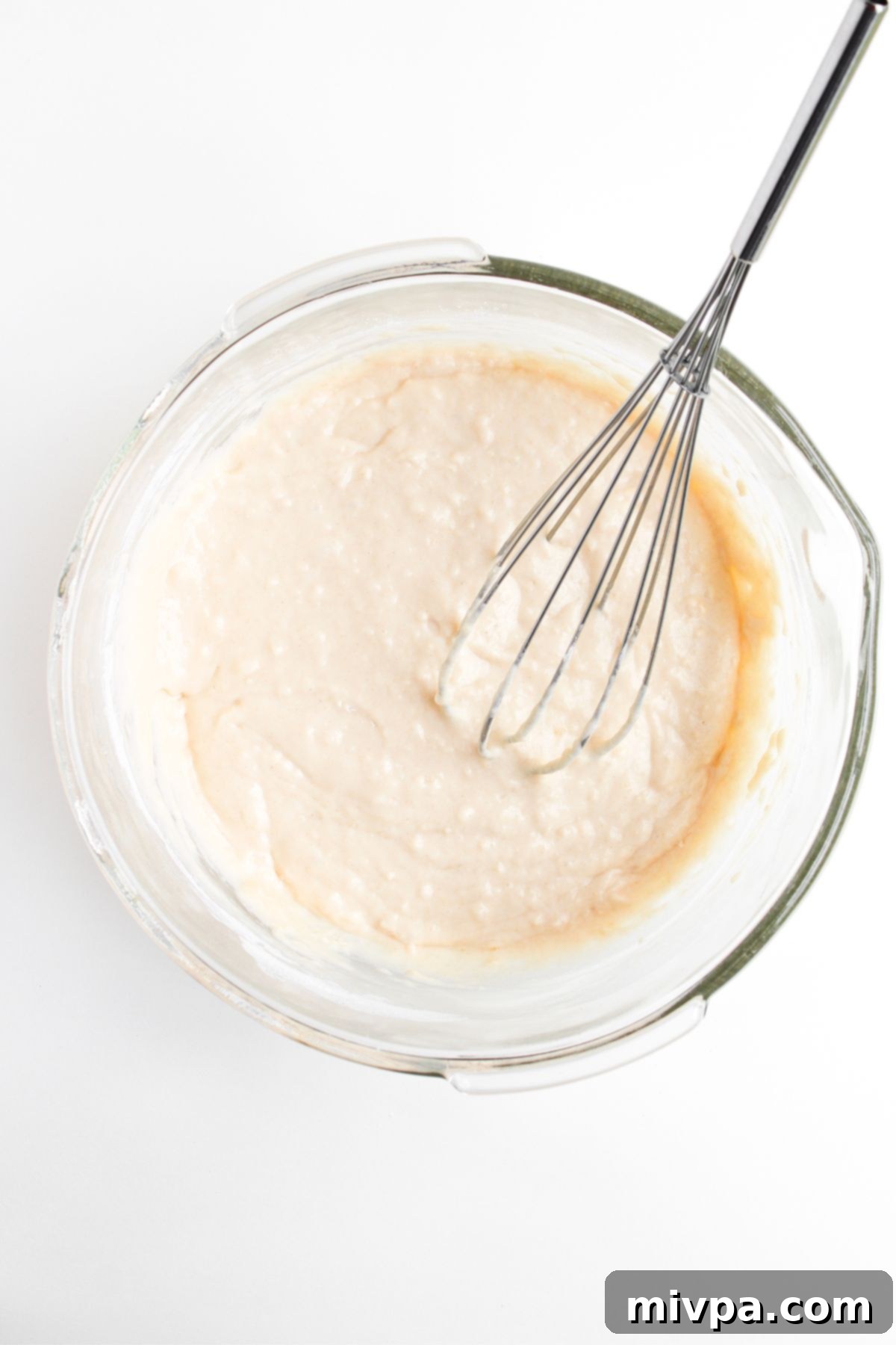 Whisking pancake batter in glass bowl