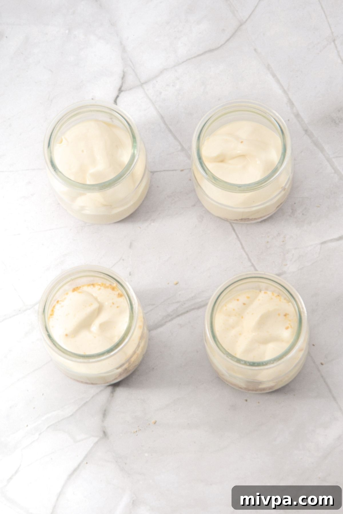 Gluten-Free Cheesecake Cups Cream cheese mixture in jars
