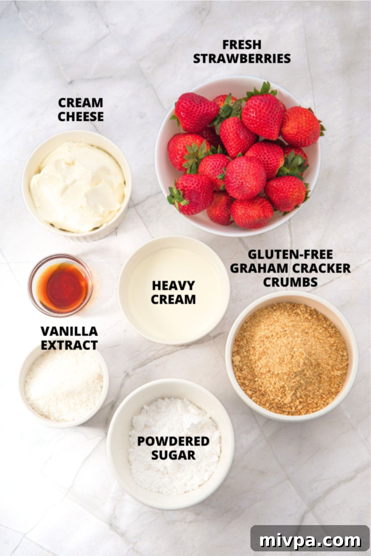 Strawberry Cheesecake Cups Recipe (Gluten-Free, No-Bake) Ingredients for strawberry cheesecake cups recipe laid out on marble board.