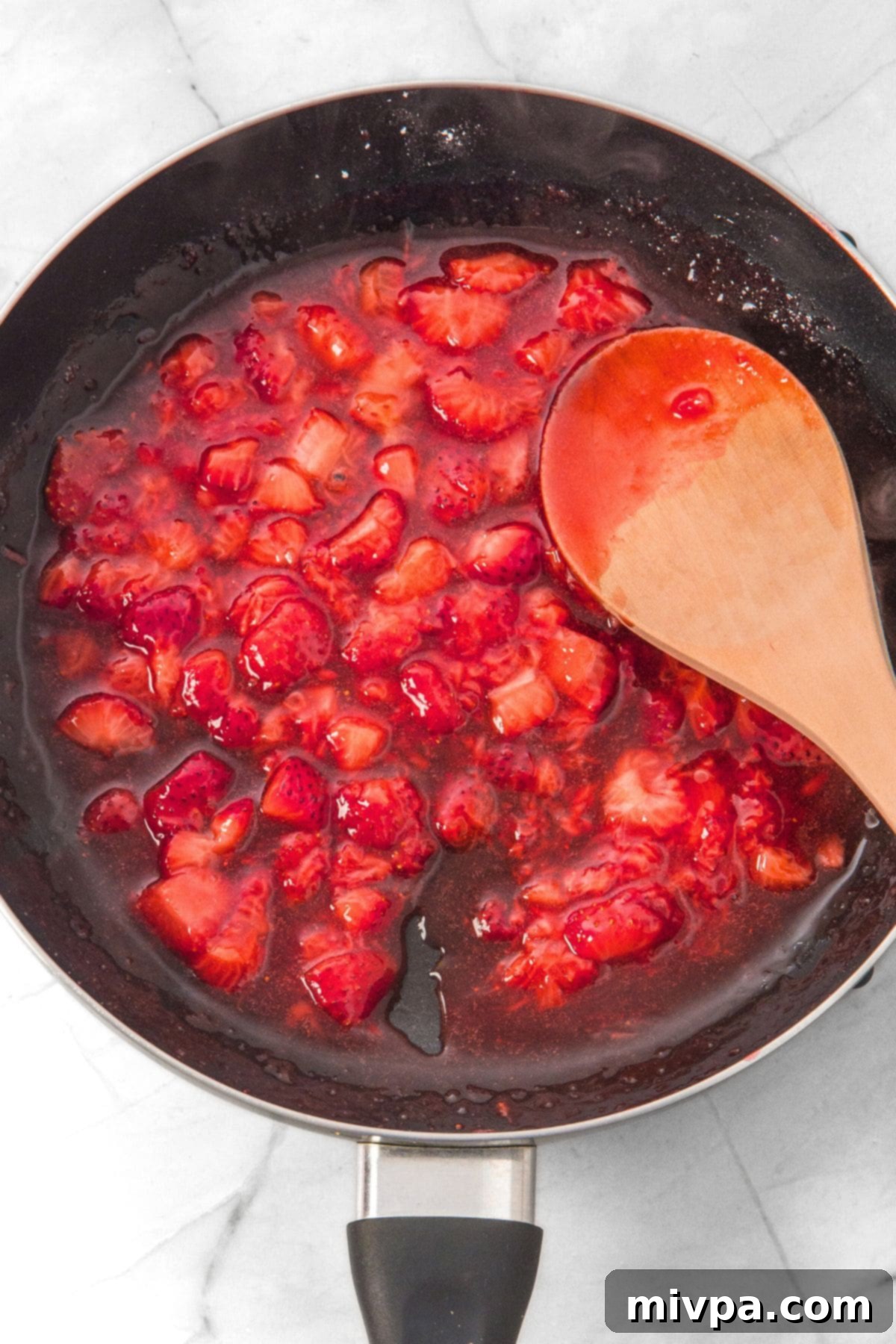 How to Make Strawberry Cheesecake Cups Cooking strawberry sauce in skillet