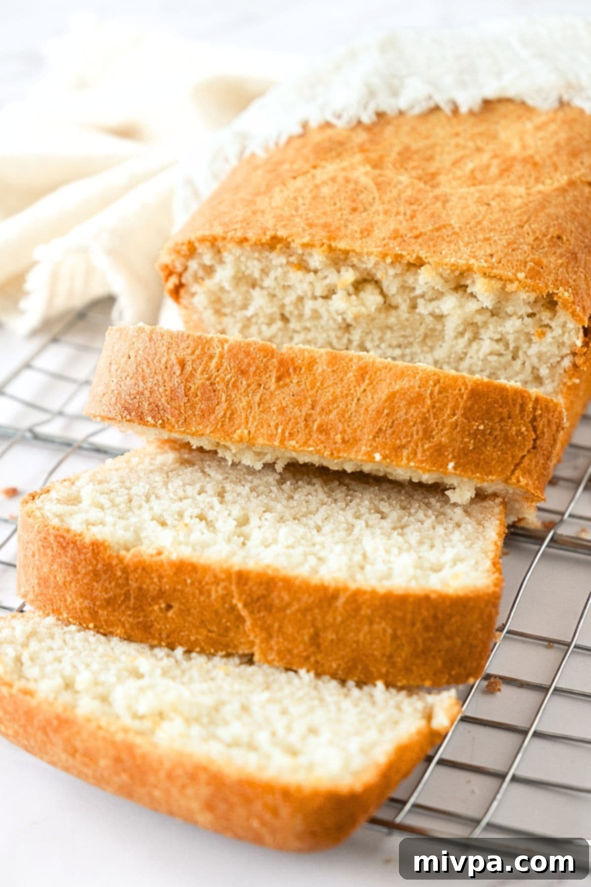 Sliced loaf of gluten-free bread without egg.