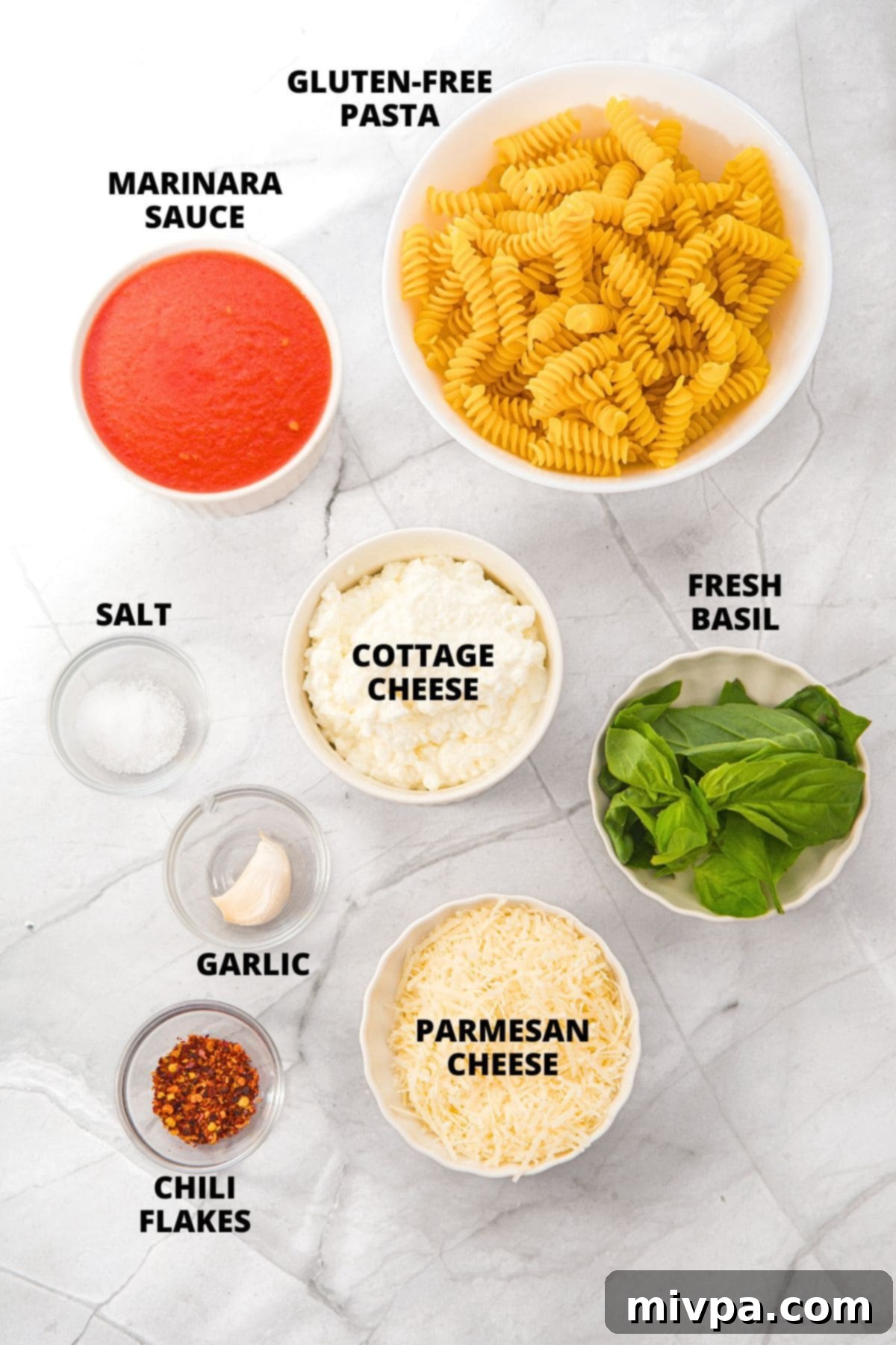 Ingredients for cottage cheese pasta sauce recipe laid out on white board.