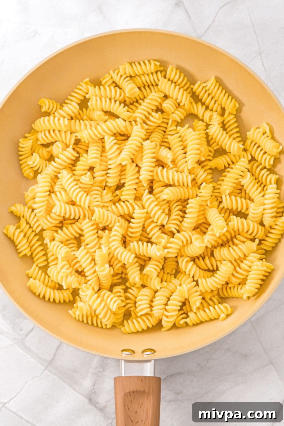 A skillet with fusilli pasta