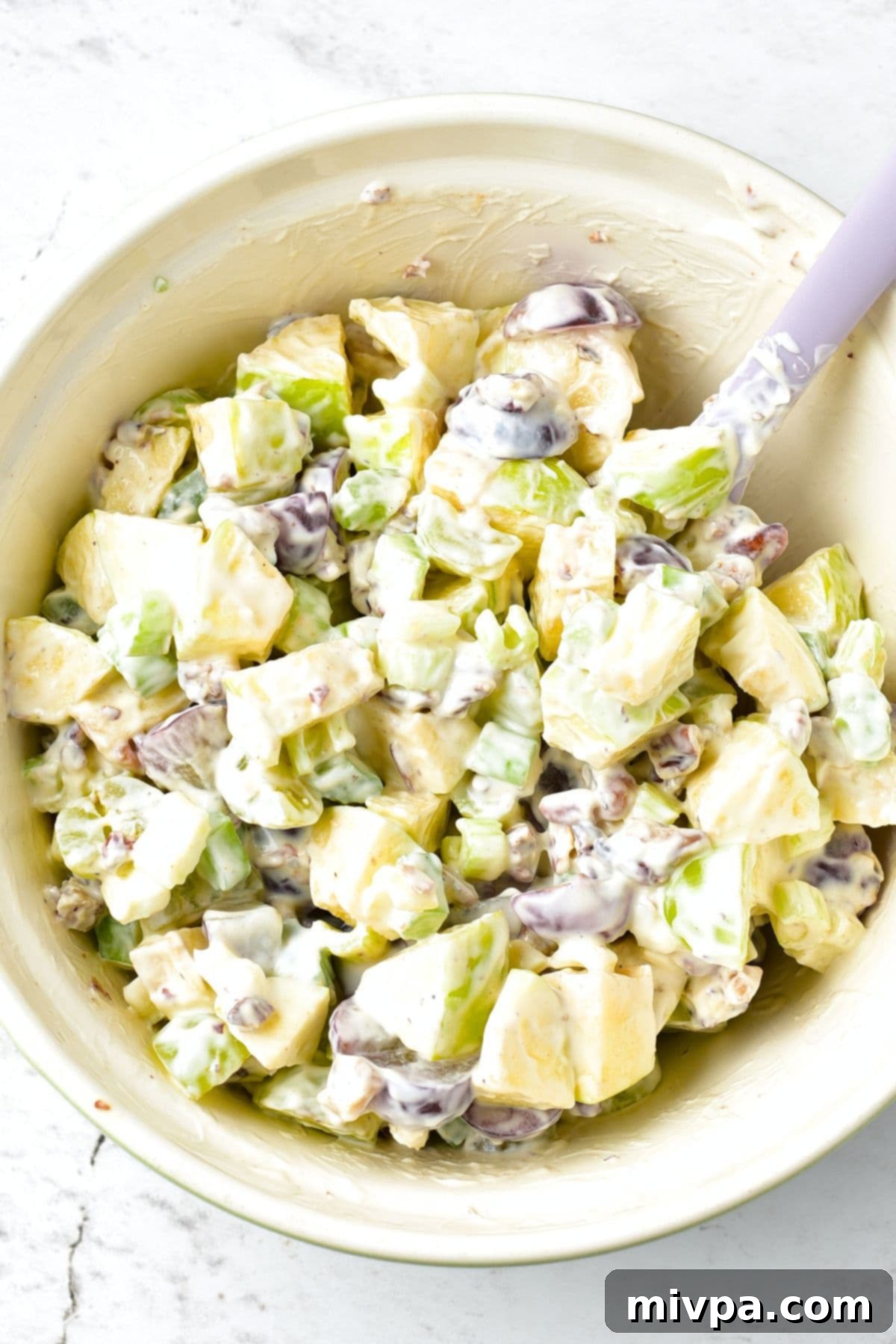 Waldorf Salad without Mayo Mixing waldorf salad in bowl