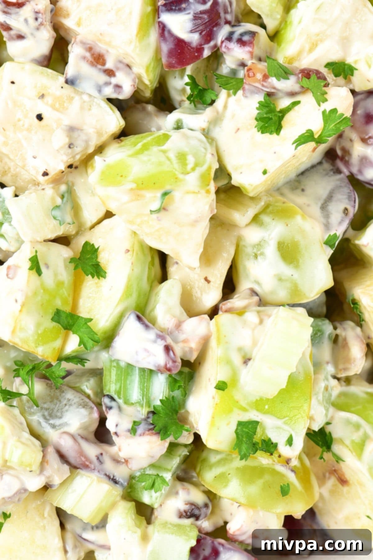 Dairy-Free Waldorf Salad Up close view of waldorf salad topped with chopped parsley