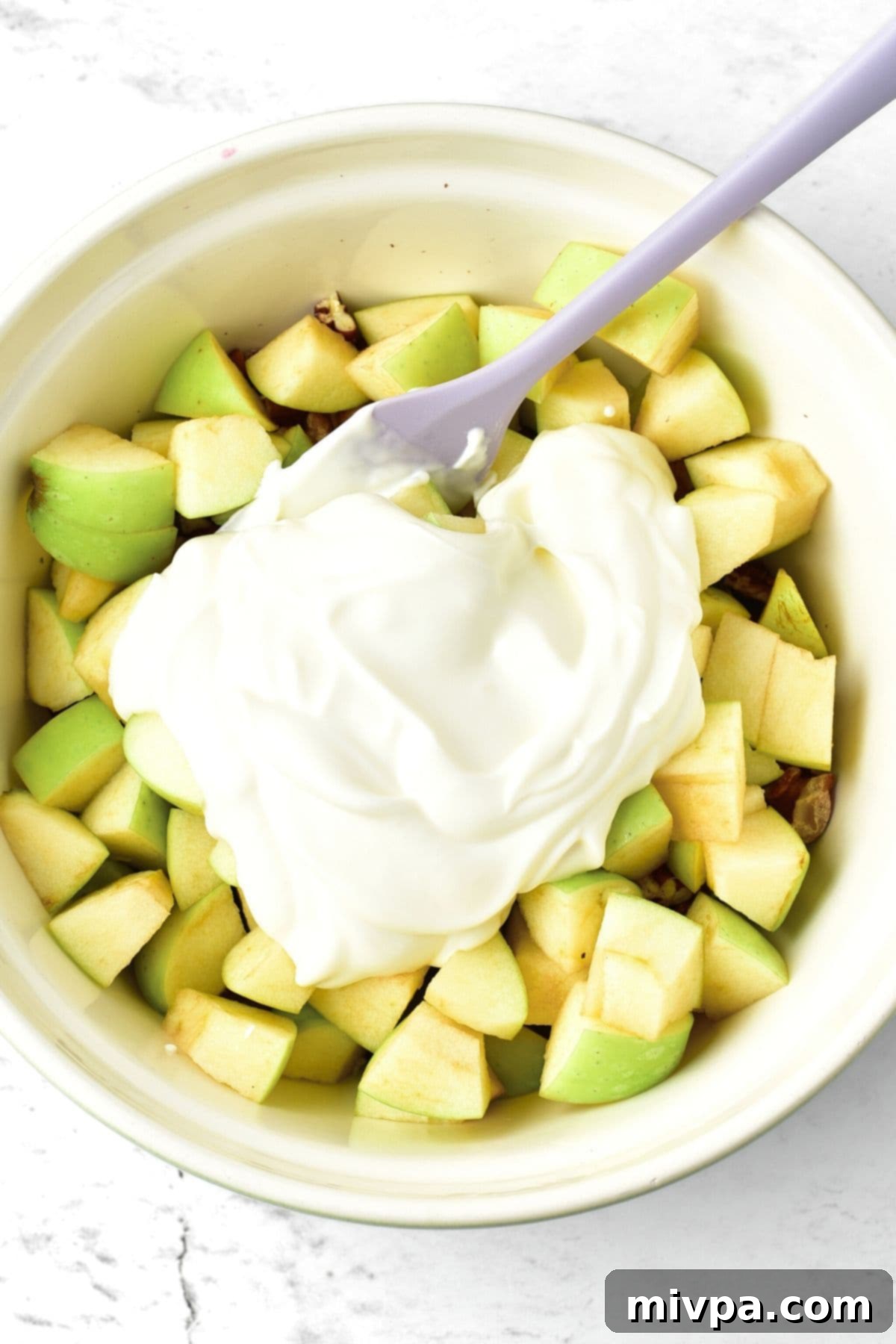 Waldorf Salad with Apples (Gluten-Free, Vegan) Creamy dressing on top of chopped apples
