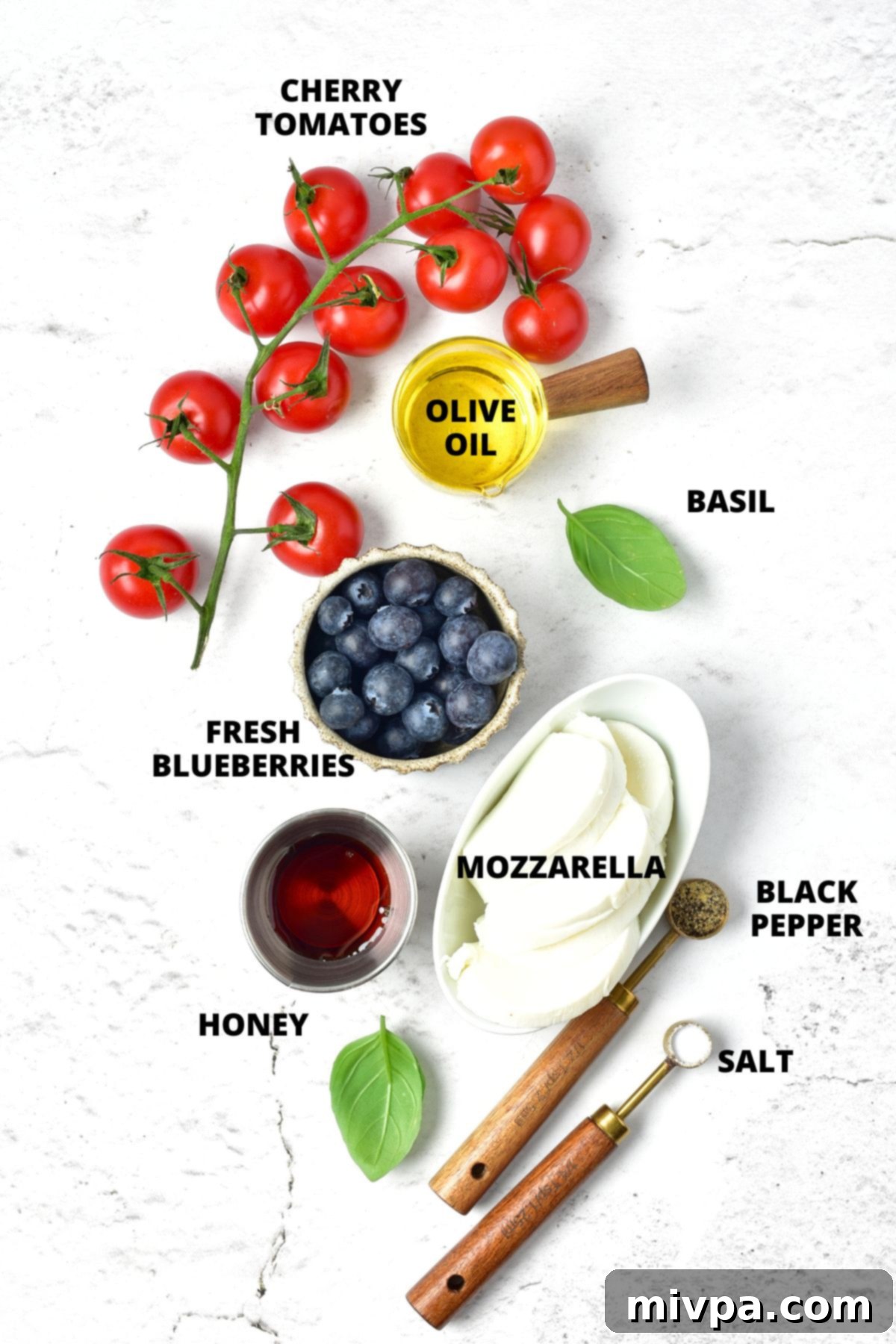 Red, White and Blue Caprese Salad Recipe (Gluten-Free) Ingredients for red white and blue caprese salad recipe laid out on marble board.