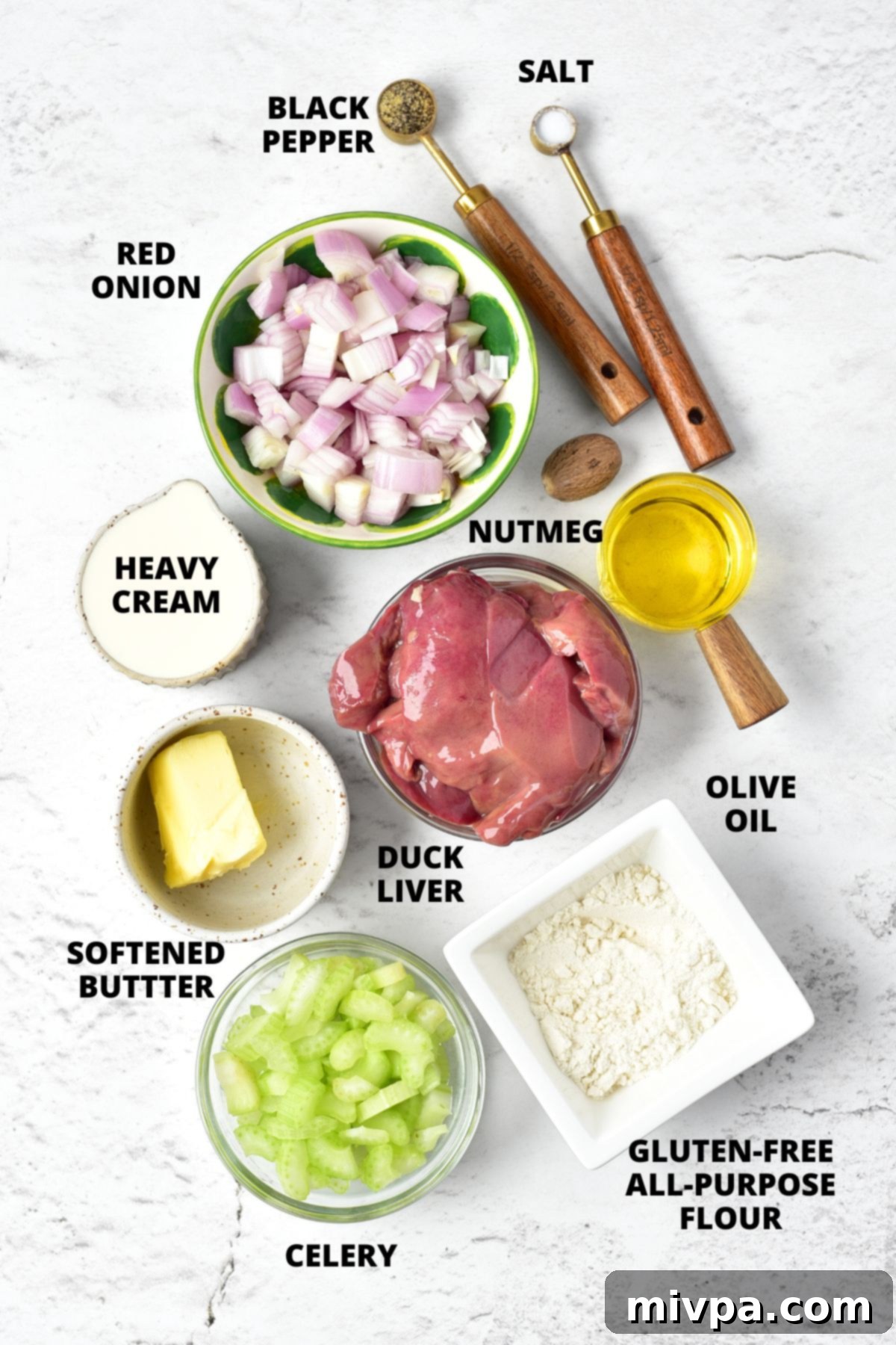 A vibrant display of fresh ingredients for duck liver pate recipe, including duck liver, vegetables, and spices, neatly arranged on a marble board.