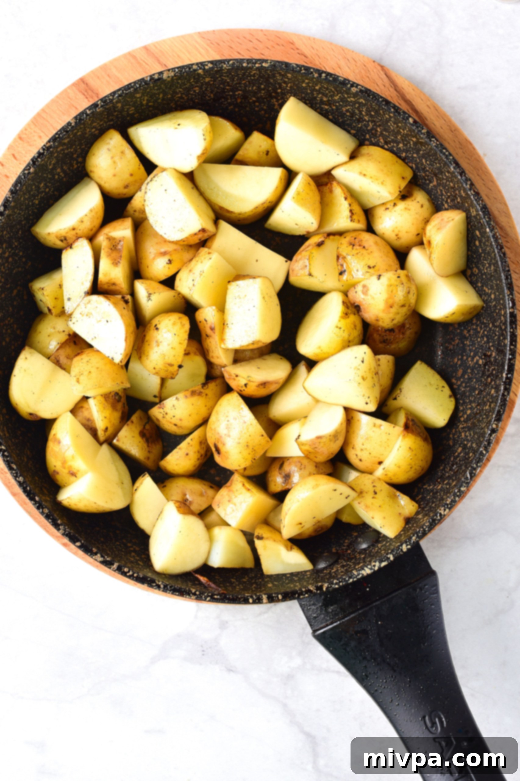 Gluten Free Stew With Beef (Dairy-Free) Baby potatoes cooking in skillet.