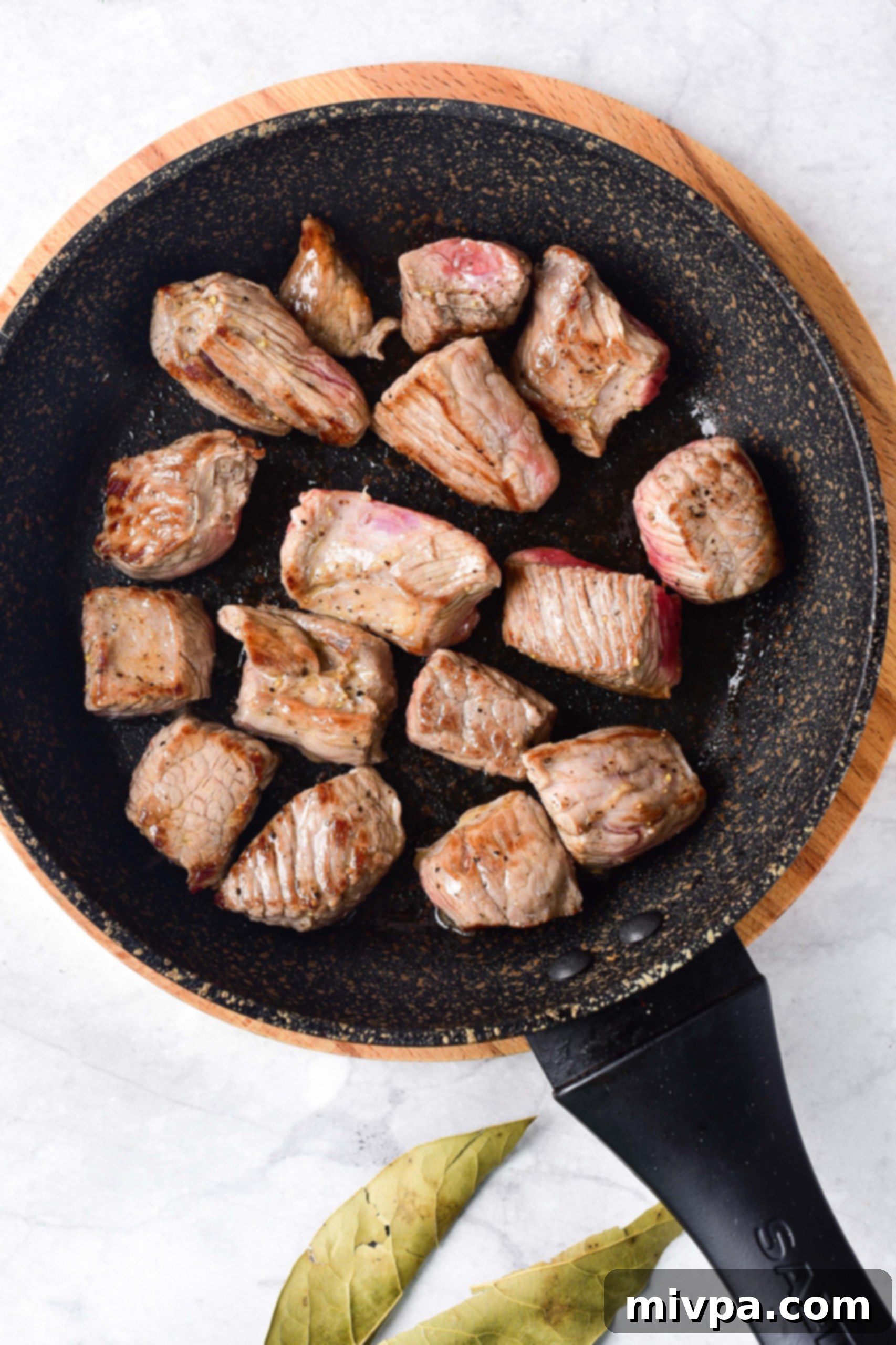 Gluten Free Beef Stew (Stovetop) Beef cubes being seared in a skillet.