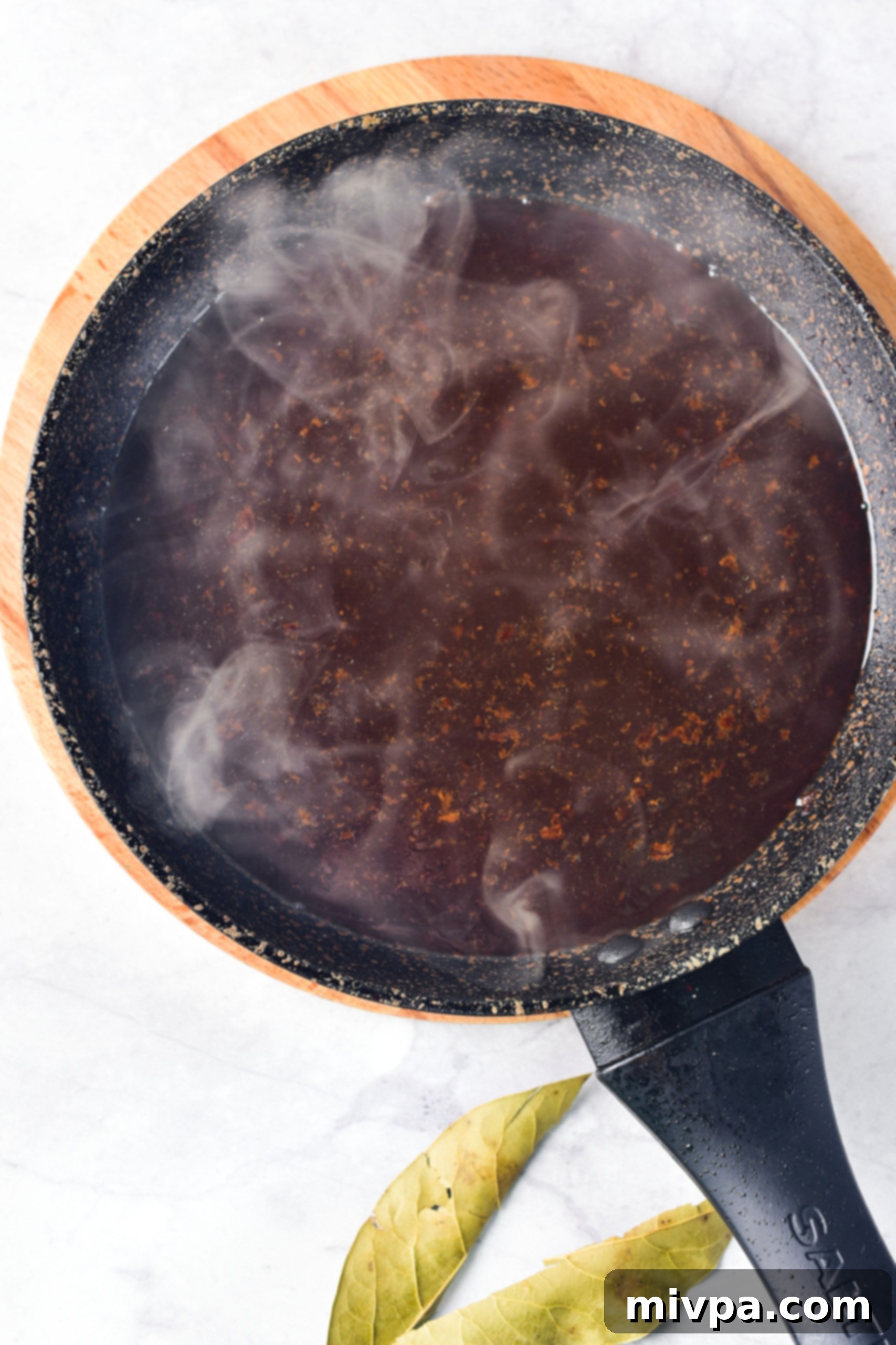 Gluten Free Beef Casserole Recipe (Dairy-Free) Beef broth mixture in a saucepan.