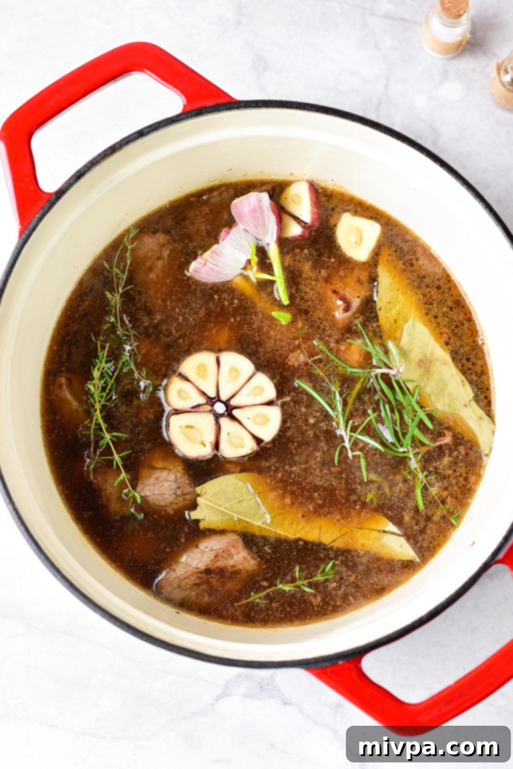 Gluten and Dairy Free Beef Stew Beef stew ingredients in a Dutch oven.