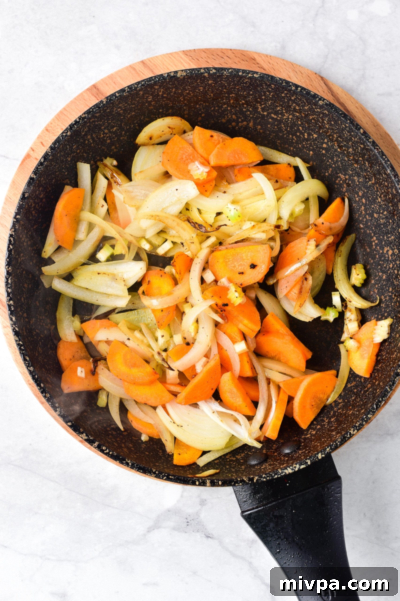 GF Beef Stew Recipe (Dairy-Free) Vegetables being sautéed in a skillet.