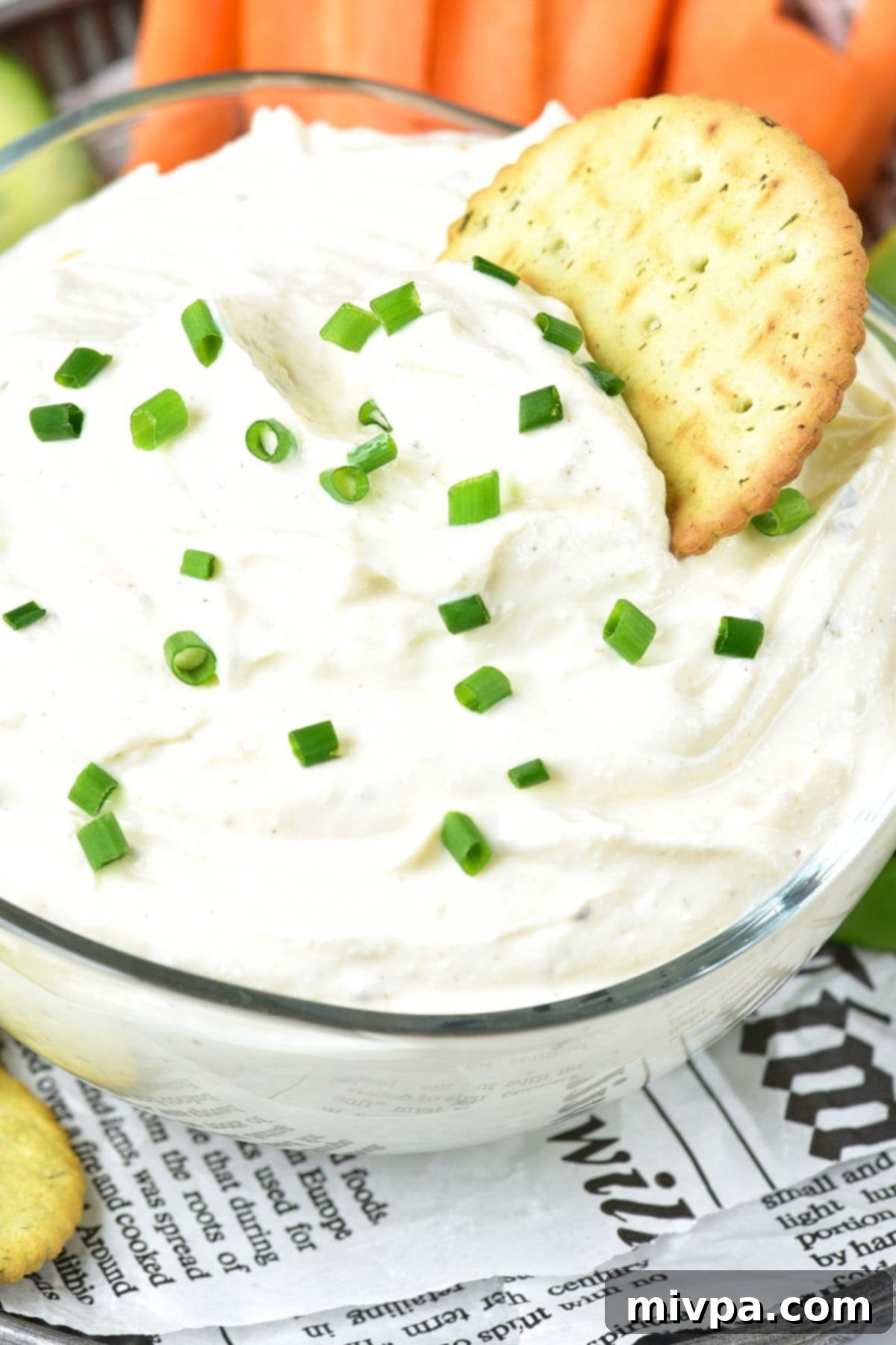 Cottage Cheese Ranch Dip (Gluten-Free) A cracker dipped in a bowl of cottage cheese ranch dip.