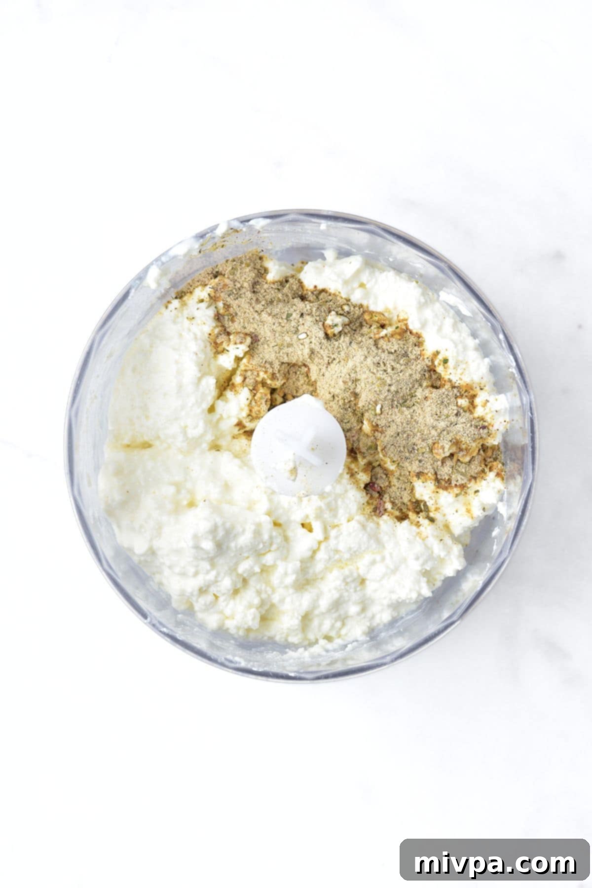 Ranch Cottage Cheese Dip Cottage cheese and ranch seasoning mix are added to a food processor.
