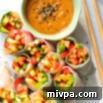 Cut veggie summer rolls and a bowl of peanut sauce