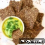 Effortless Gluten-Free Vegan Flaxseed Crackers 4 Flaxseed crackers and guacamole, a perfect healthy snack pairing.