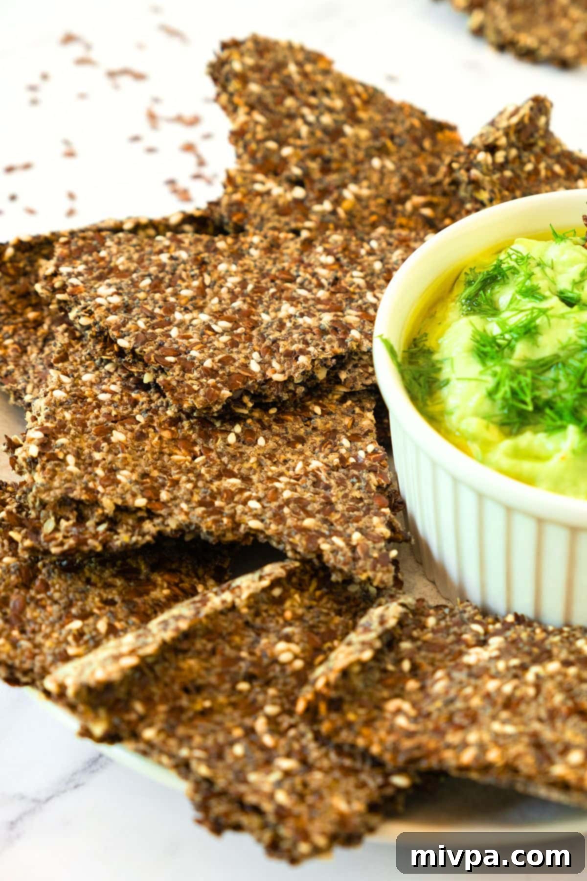Chia and Flaxseed Crackers Recipe A beautifully arranged plate of golden chia and flaxseed crackers, ready for serving or snacking.