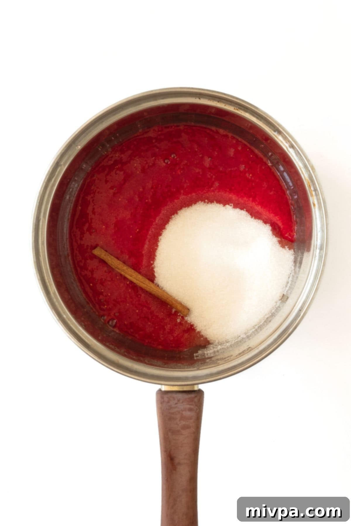 How to Make Strawberry Lemonade Strawberry puree, sugar and cinnamon stick in pot.