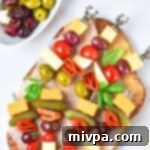 Charcuterie skewers on wooden board.