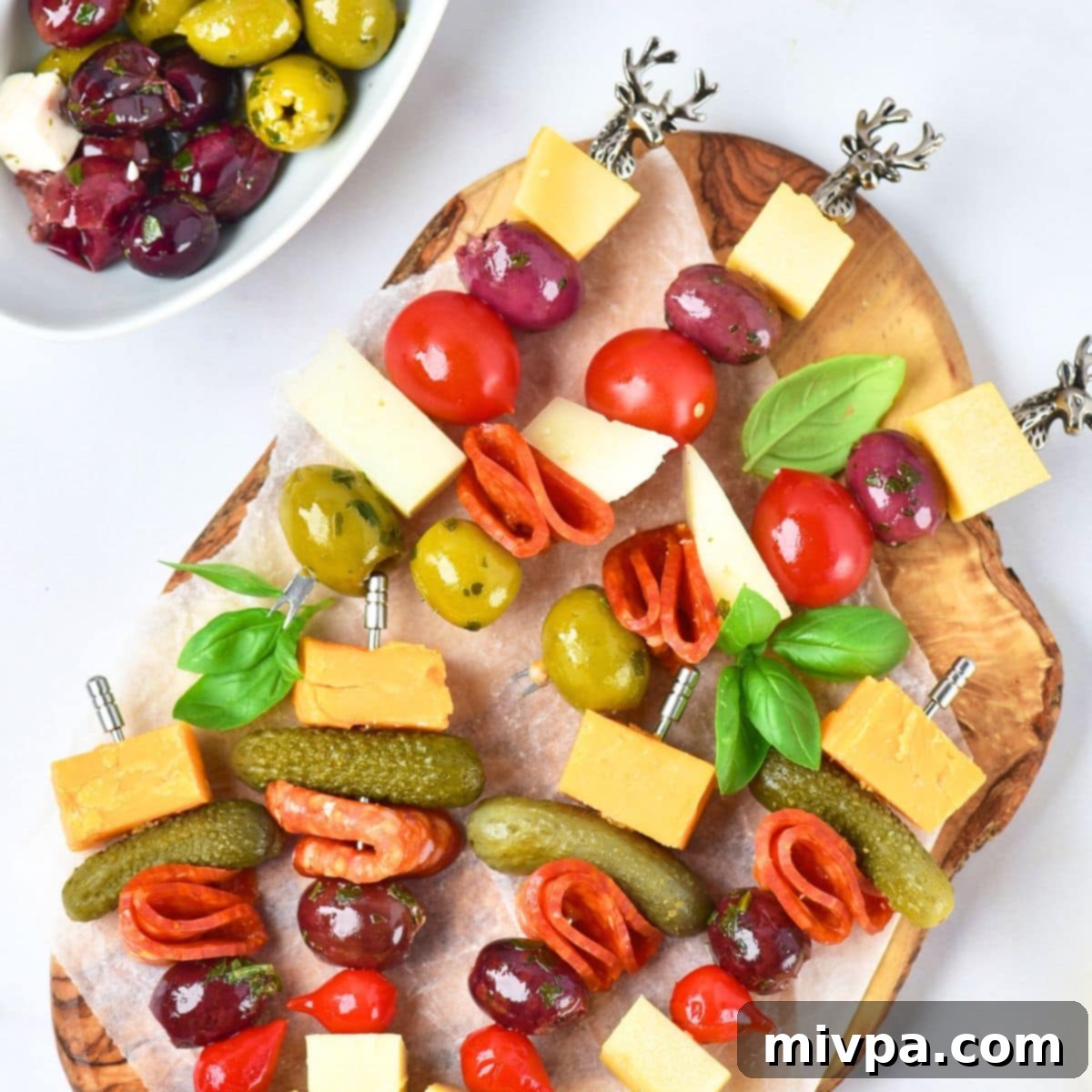 Charcuterie skewers on wooden board.