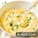 A spoon in a bowl of egg salad.