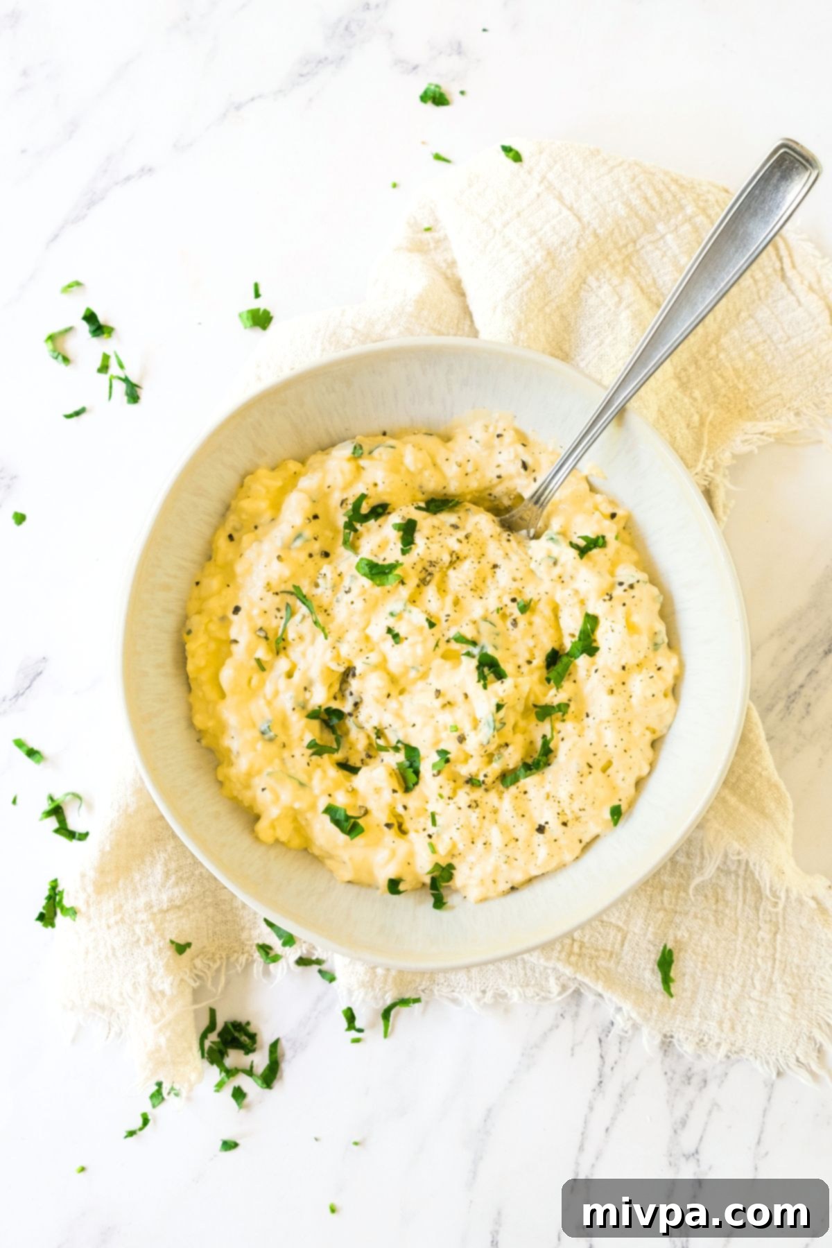 Top down view of a bowl of parsley topped gluten-free egg salad.