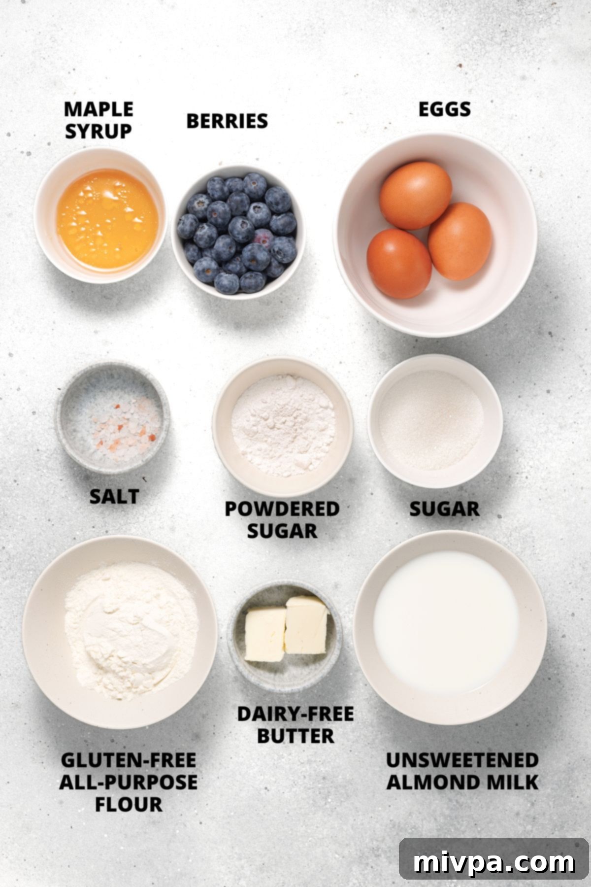 Easy Gluten-Free Dutch Baby Recipe (Dairy-Free) Ingredients for gluten-free dutch baby recipe laid out on white board.