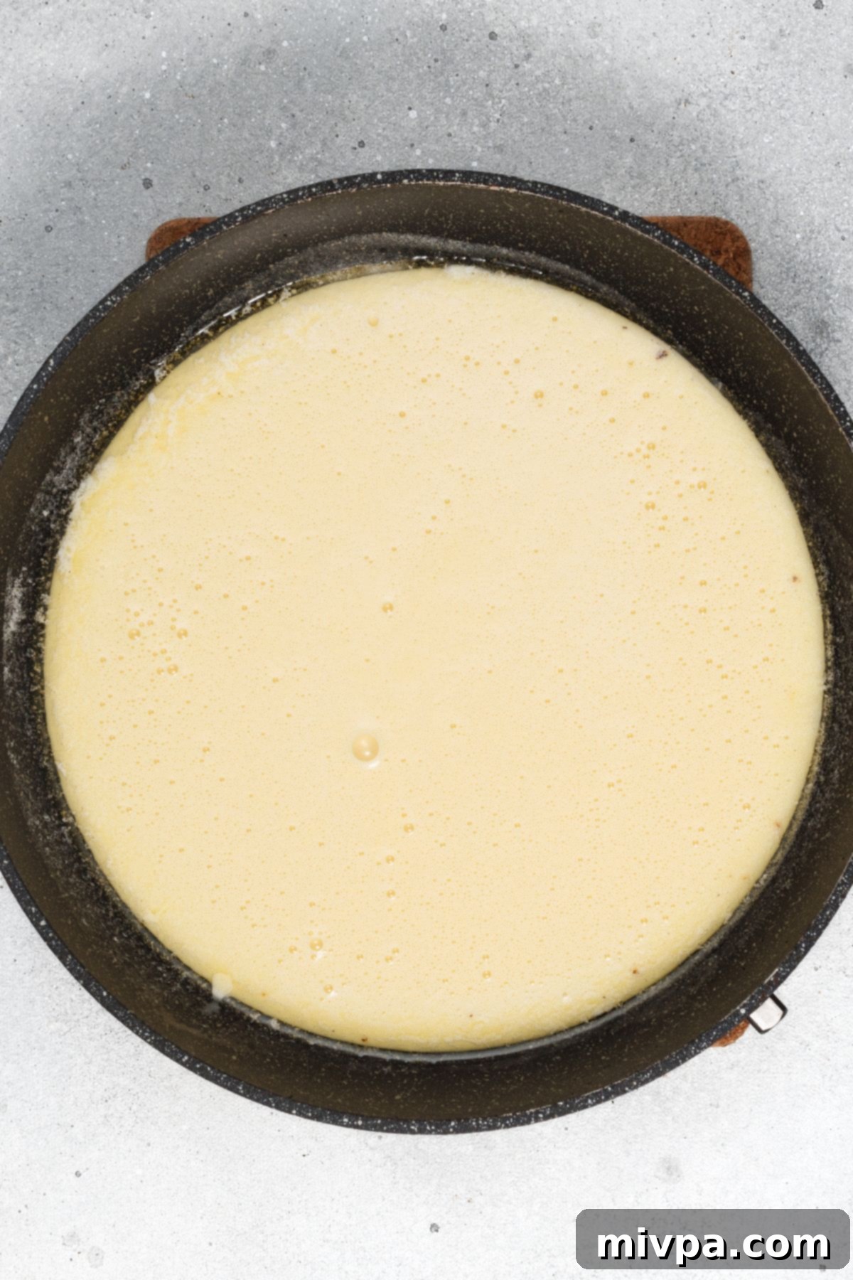 Easy Gluten-Free Dutch Baby (Dairy-Free) Pancake batter in cast iron skillet