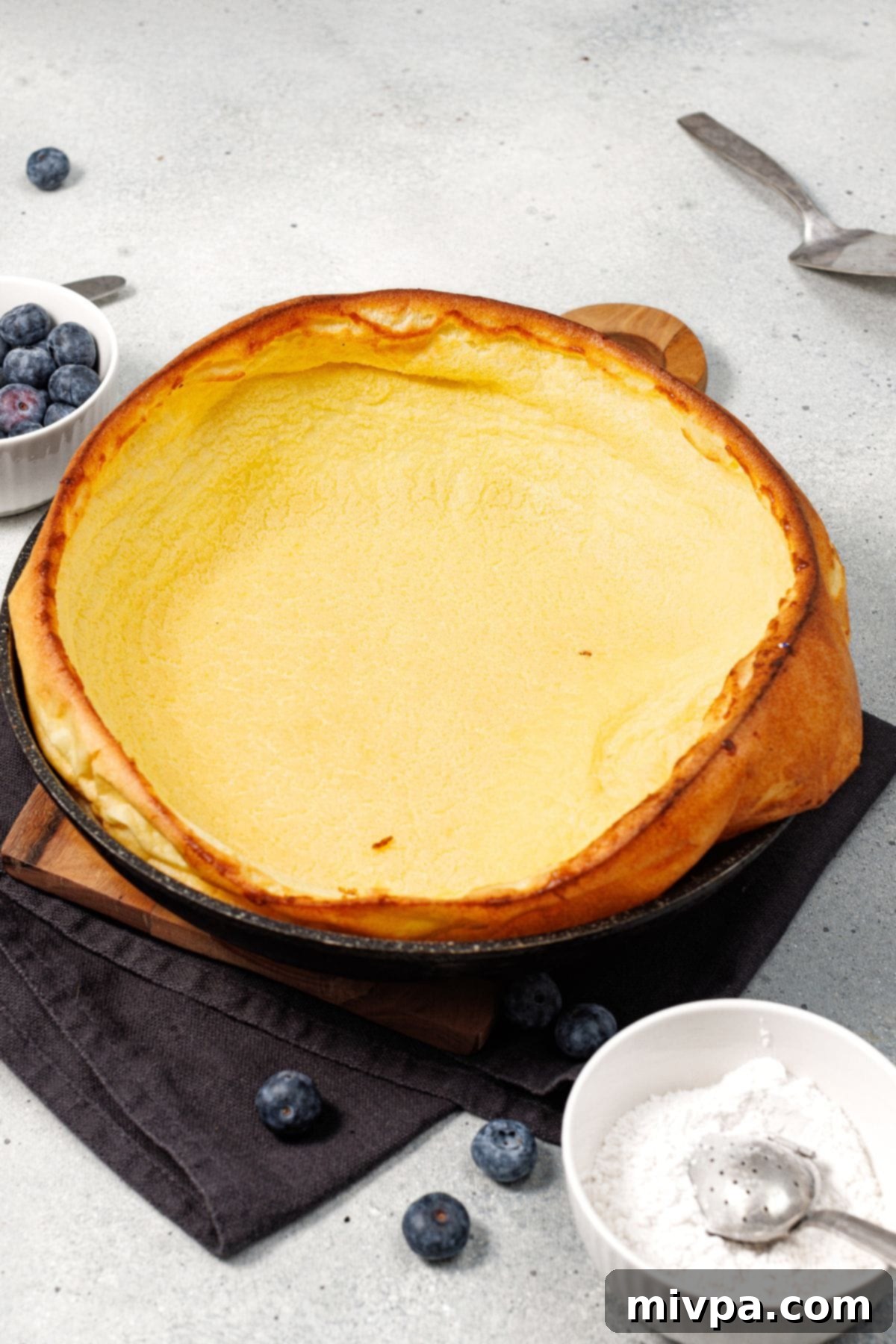 Dutch Baby (Gluten-Free) Freshly baked Dutch baby (gluten-free) in cast iron skillet