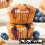 A stack of blueberry banana oatmeal muffins on plate