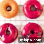 Easy 10 Minute Gluten Free Vegan Blueberry Glaze 2 Blueberry glazed donuts elegantly arranged on a wire rack, glistening with sweet berry topping.