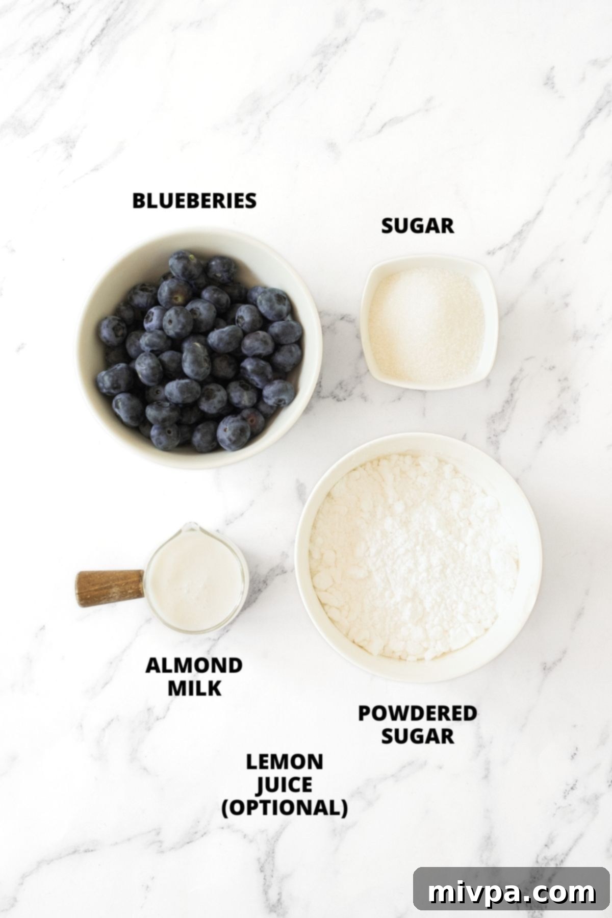 Blueberry Glaze Recipe (Gluten-Free, Vegan) All the necessary ingredients for homemade blueberry glaze recipe, meticulously laid out on a marble board, ready for preparation.