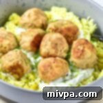 A bowl of turkey feta meatballs over rice