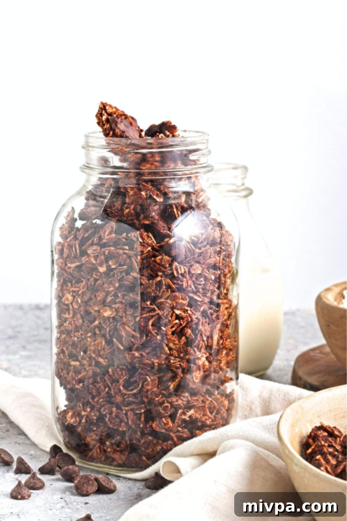 Chocolate Coconut Granola (Gluten-Free, Vegan) A glass jar with chocolate granola