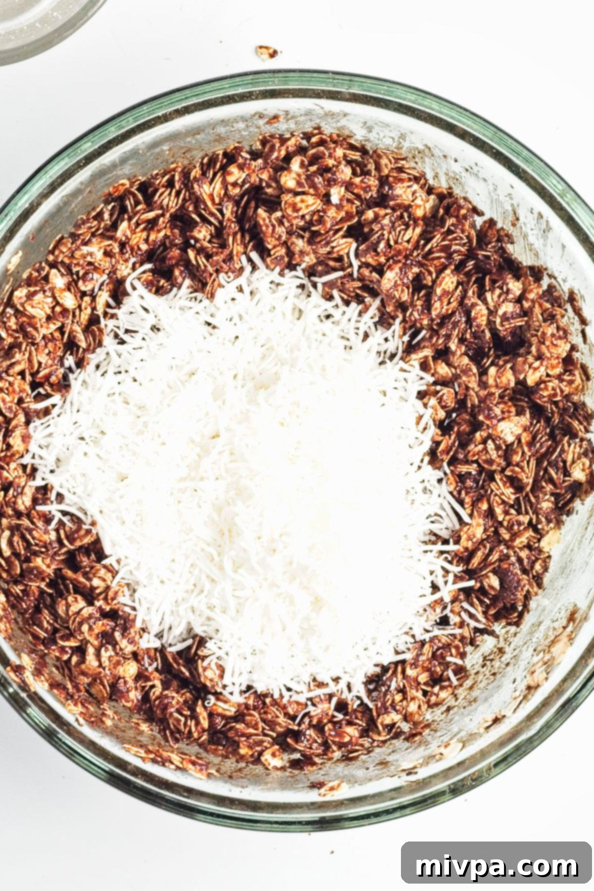 Coconut and Dark Chocolate Granola A bowl of chocolate granola topped with shredded coconut