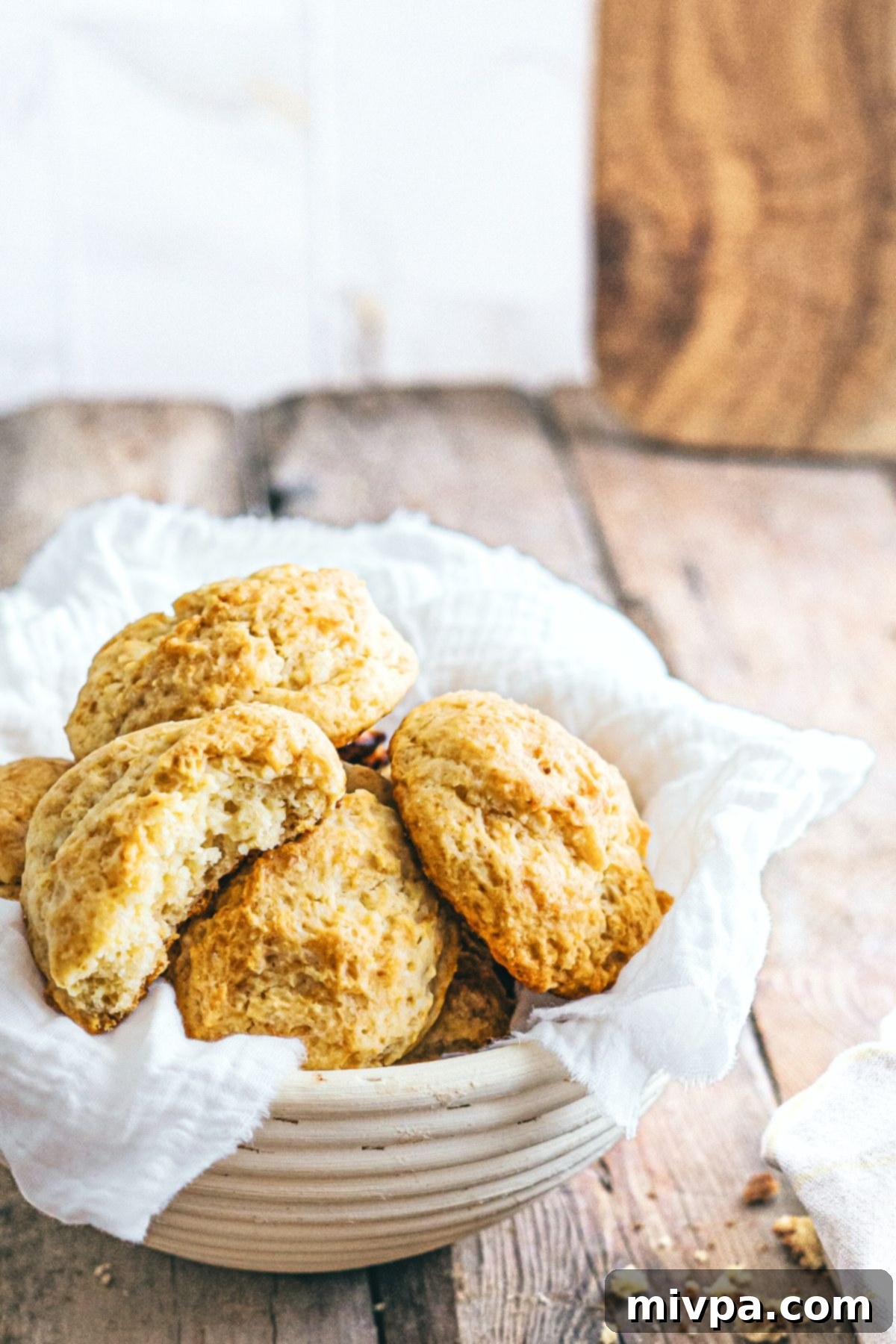 A bowl filled with warm gluten-free dairy-free biscuits, ready to be served with accompaniments.