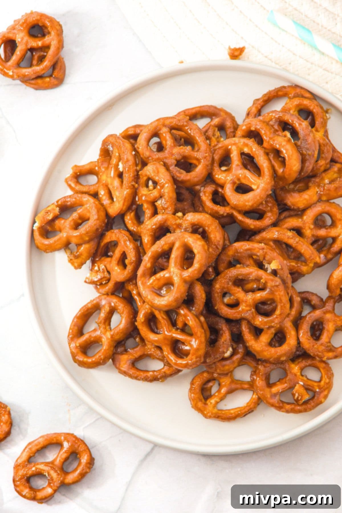 Guilt-Free Butter Toffee Pretzel Bliss 2 A plate generously piled with golden brown gluten-free butter toffee pretzels.