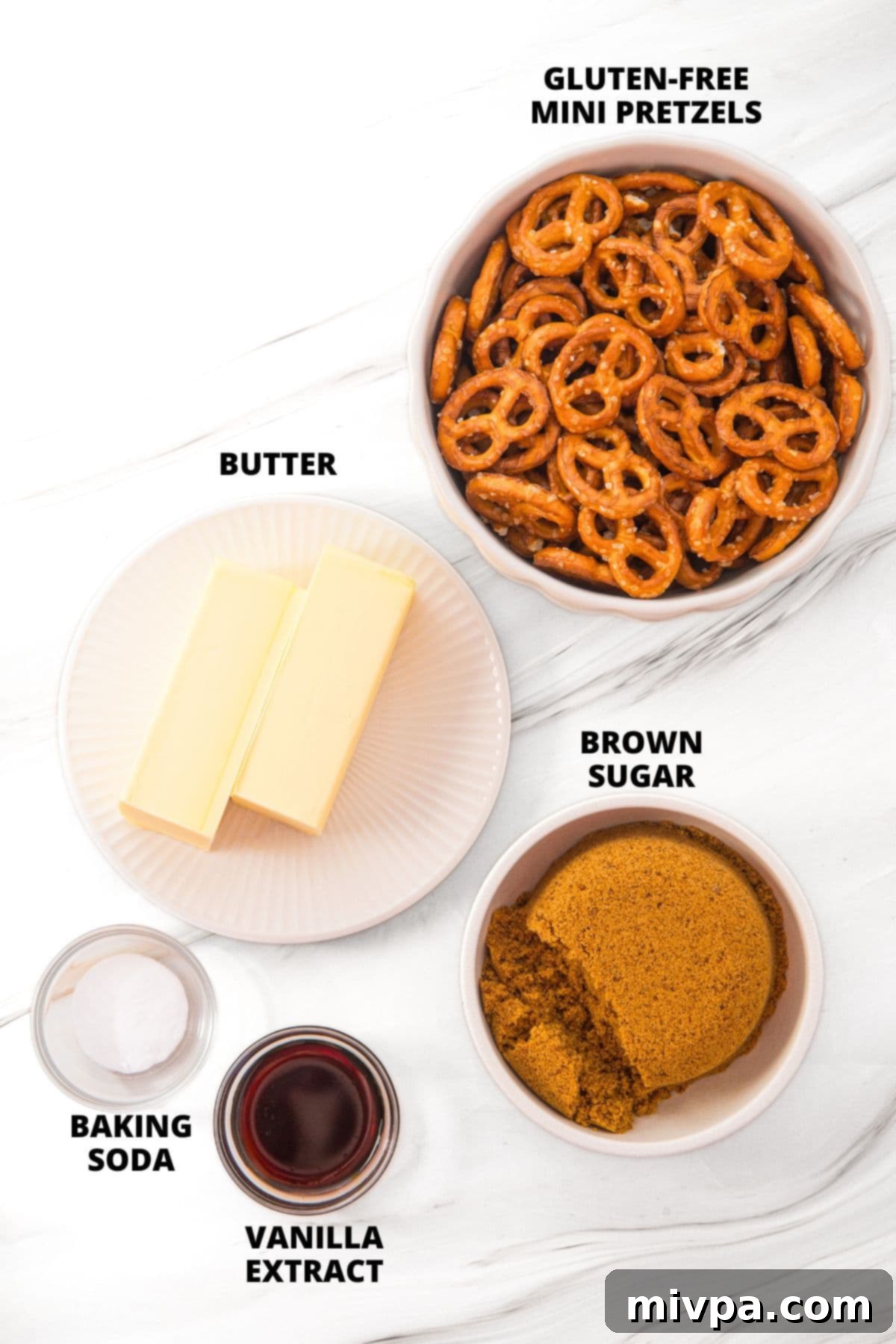 Butter Toffee Pretzels Recipe (Gluten-Free, Dairy-Free Option) All the ingredients for the butter toffee pretzels recipe laid out neatly on a marble board, including butter, brown sugar, pretzels, vanilla, and baking soda.