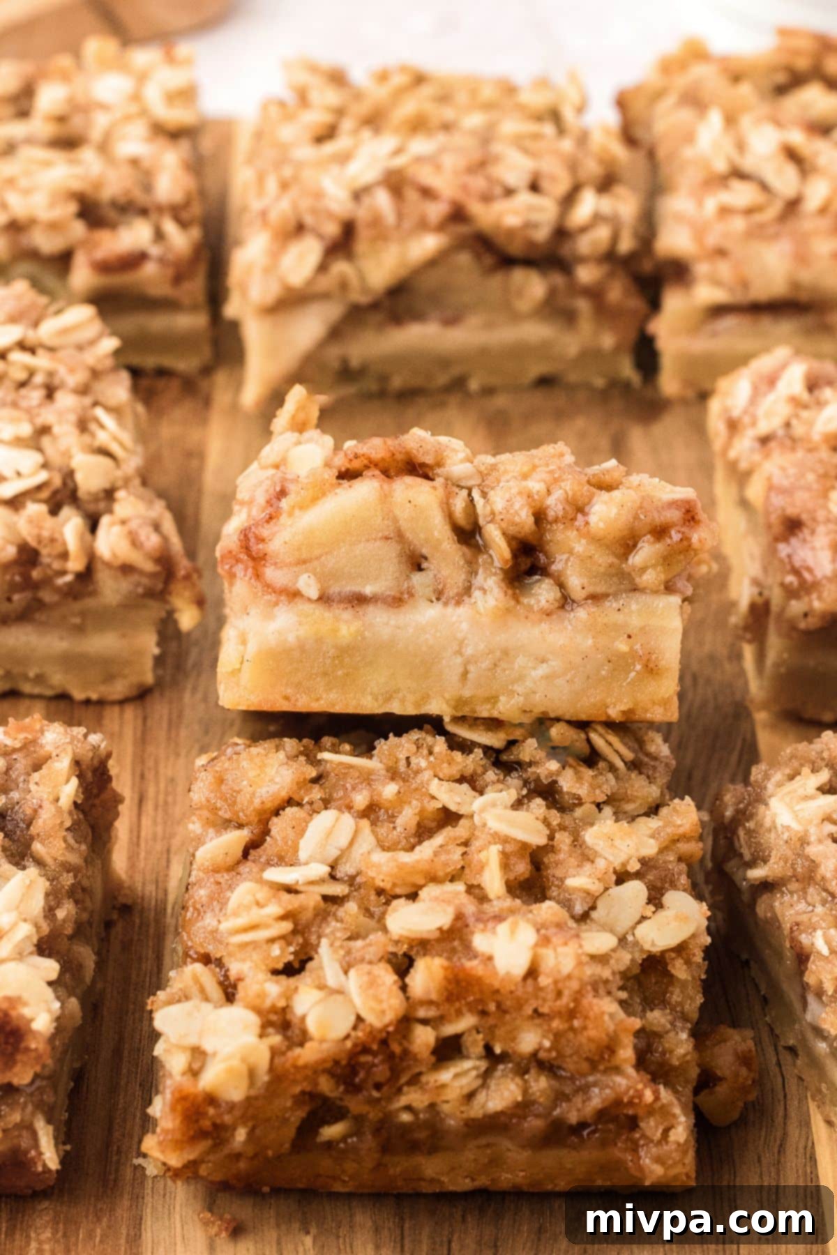 Gluten-Free Apple Pie Squares (Vegan) Apple pie squares on wooden board, ready to serve.