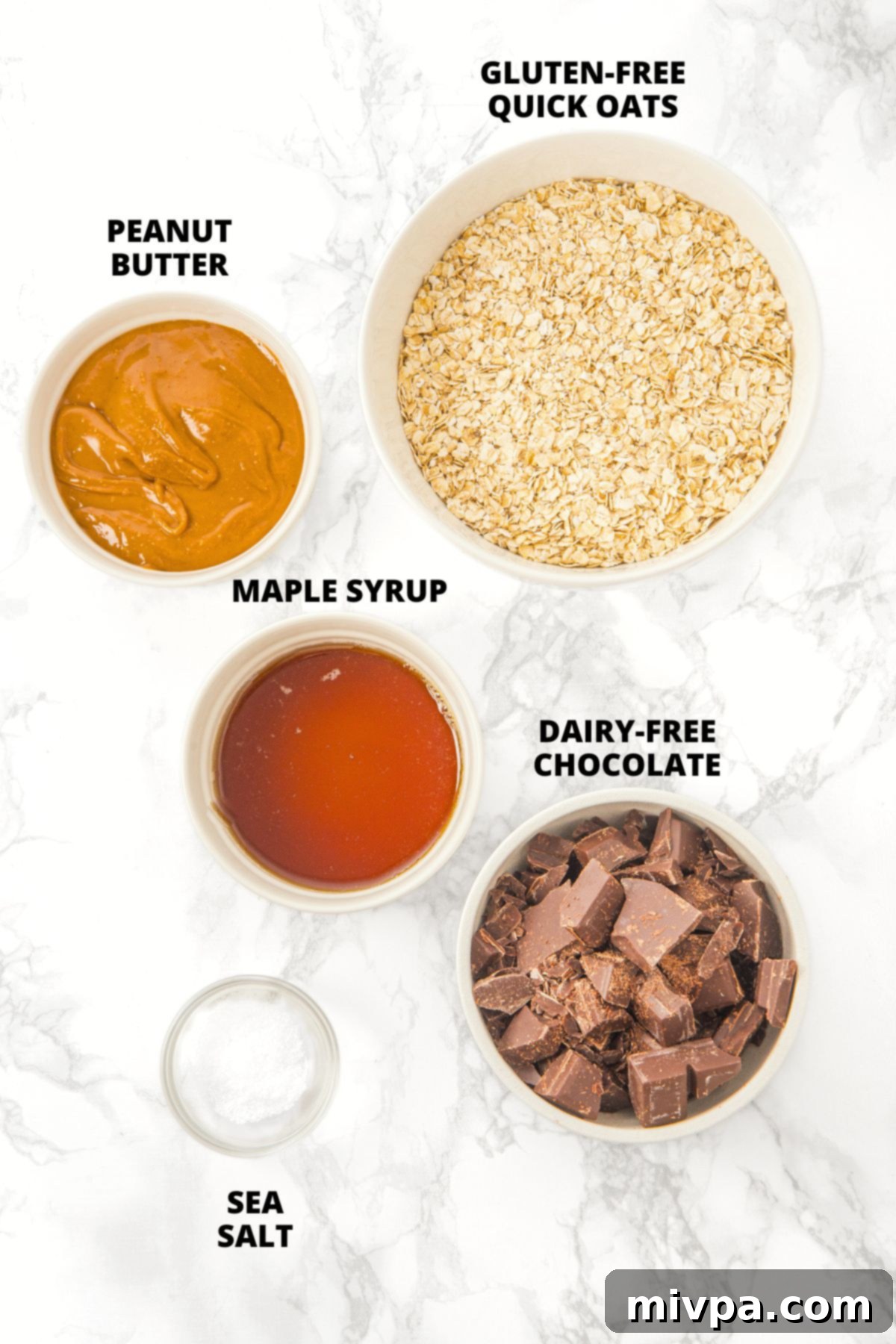 Peanut Butter Chocolate Oatmeal Bars Recipe (Gluten-Free, Vegan) Ingredients for peanut butter chocolate oatmeal bars recipe meticulously laid out on a marble board.