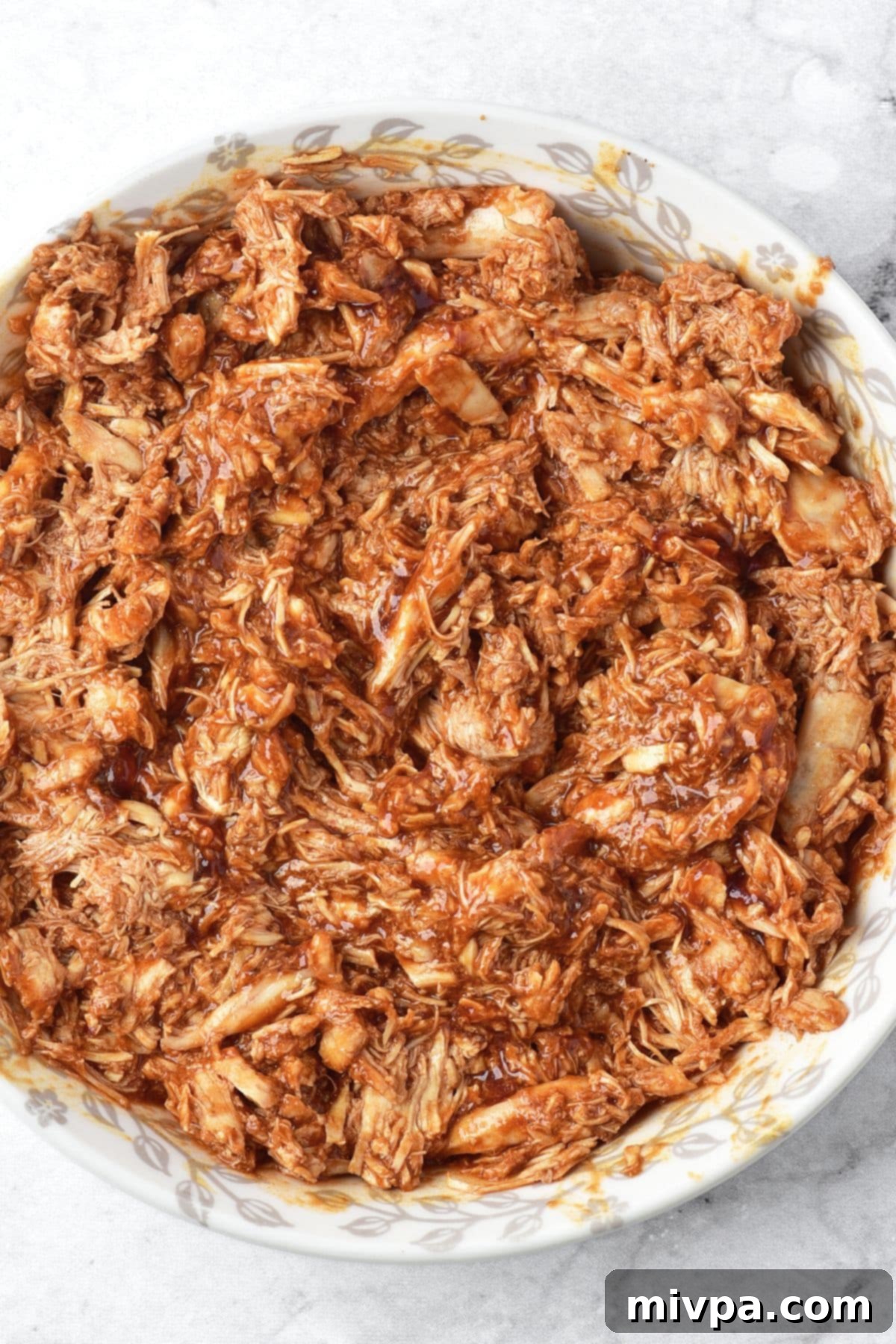 Gluten Dairy-Free Chicken Birria A bowl of flavorful shredded chicken birria, ready for taco filling.