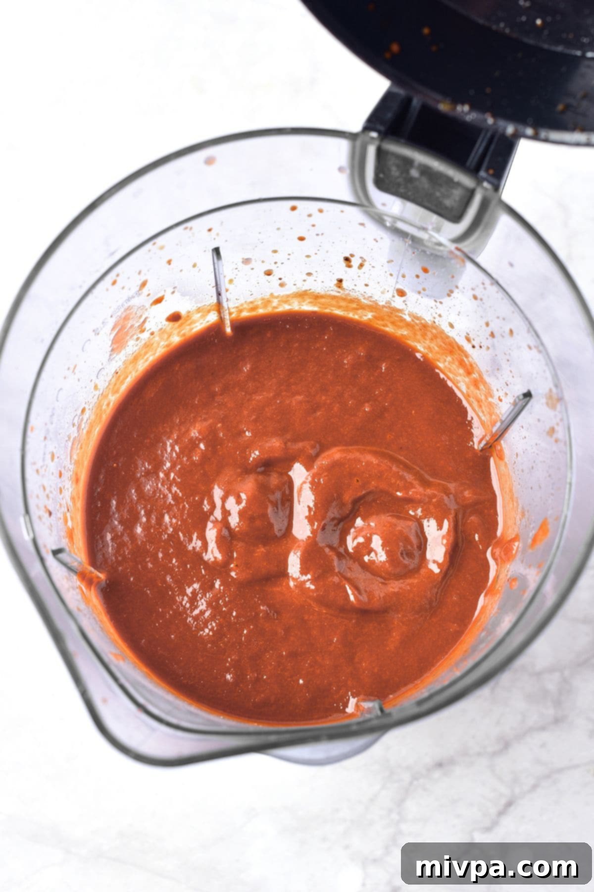 Delicious Chicken Birria Tacos Gluten Free Dairy Free 4 Processed birria sauce in an electric blender, achieving a smooth consistency.